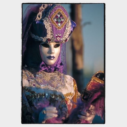 Elegant Carnival Mask and costume in Venice sunset light